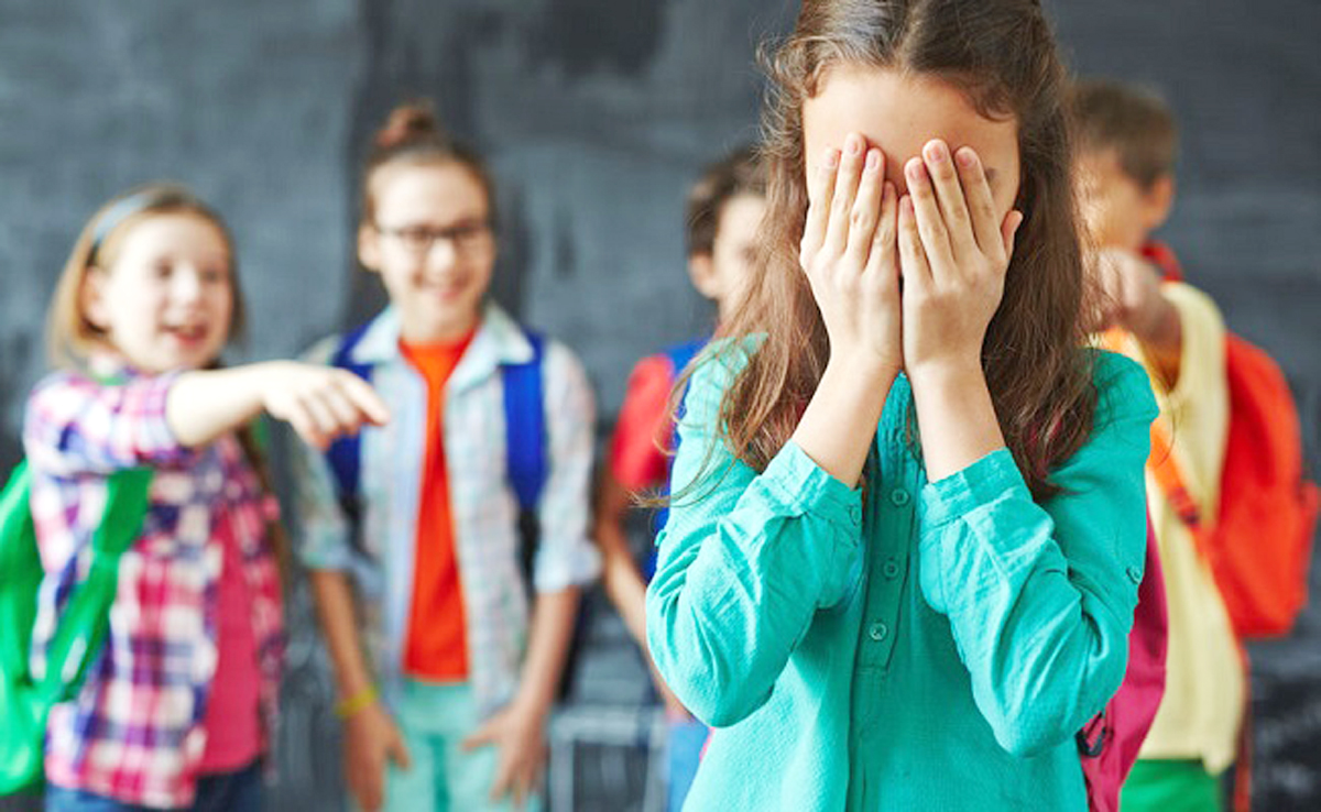 54480510 - schoolgirl crying on background of classmates teasing her
