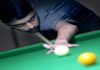 A cueist aiming at target during 26th Billiards and Snooker Championship at Billiards Hall, MA Stadium in Jammu on Wednesday. -Excelsior/Rakesh