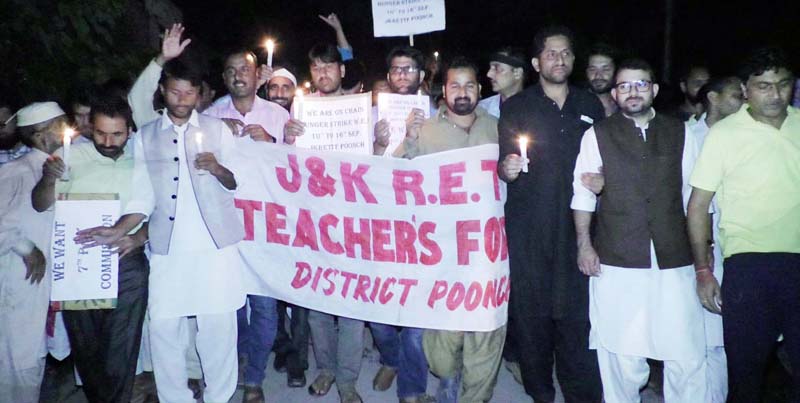 RET and SSA teachers taking out candle light procession in Poonch town on Friday. -Excelsior/ Ramesh Bali. RET and SSA teachers taking out candle light procession in Poonch town on Friday. -Excelsior/ Ramesh Bali.