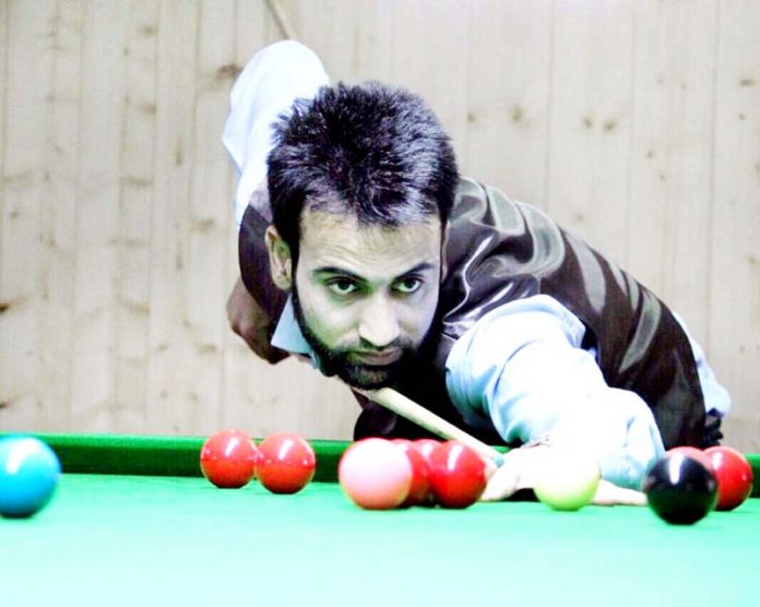 Cueist aiming at target during a match of Srinagar District Sr Snooker Championship on Saturday.