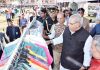 Governor SP Malik looking at products at exhibition of J&K Khadi & Village Industries Board in Srinagar on Tuesday.