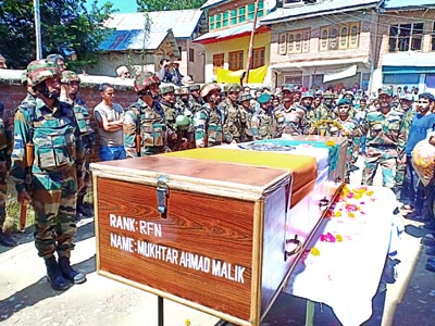 Tributes being paid to martyr on Tuesday. -Excelsior/ Sajad Dar Tributes being paid to martyr on Tuesday. -Excelsior/ Sajad Dar
