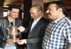 Secretary Tourism, Rigzin Samphel and Director Tourism Kashmir, Tasaduq Jeelani presenting special traditional tea pot to Bollywood Actor/Director Manoj Bajpayee at Srinagar on Wednesday.