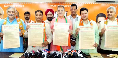 BJP leaders releasing poll manifesto at Jammu on Sunday. -Excelsior/Rakesh BJP leaders releasing poll manifesto at Jammu on Sunday. -Excelsior/Rakesh