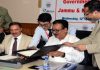 Principal Secretary, Finance, Navin Kumar Choudhary and Chairman & CEO, J&K Bank, Parvez Ahmad, signing MoU at Srinagar on Wednesday.