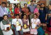 Winners of Inter-School Hindi Debate Competition posing for a group photograph along with dignitaries and officials in Jammu.