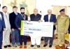 Governor, Satya Pal Malik presenting a cheque of Rs 10 lakh to Surya Bhanu Pratap in Srinagar on Saturday.
