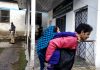 A youth carries an elderly woman to polling station in Bhaderwah on Wednesday. — Excelsior/Tilak Raj