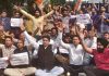 Youth Cong activists staging protest dharna outside J&K Bank head office at Railway Road in Jammu on Wednesday.