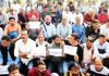 Media persons during protest against IGP Traffic at Maharaja Hari Singh statue near Tawi Bridge in Jammu on Monday. -Excelsior/Rakesh