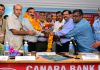 Canara Bank employees garlanding union leaders during state committee conference at Jammu on Thursday.