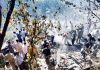 Local people and policemen trying to extinguish fire in Seru village of Bani Tehsil on Saturday.-Excelsior/ Pardeep