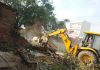 A machine demolishing a structure during a demolition drive at Kathua on Thursday.