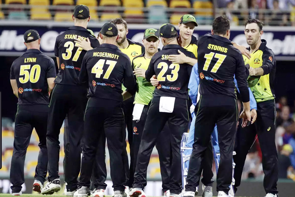 Australia players celebrate after winning the first T20 International cricket match against India in Brisbane on Wednesday. Australia players celebrate after winning the first T20 International cricket match against India in Brisbane on Wednesday.