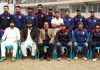 J&K Ranji trophy team posing for a group photograph alongwith Manager and Coach after thrashing Tripura at Sher-i-Kashmir stadium in Srinagar on Friday.