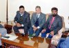 Advisor to Governor Khurshid Ahmad Ganai meeting a delegation of fruit growers on Friday.