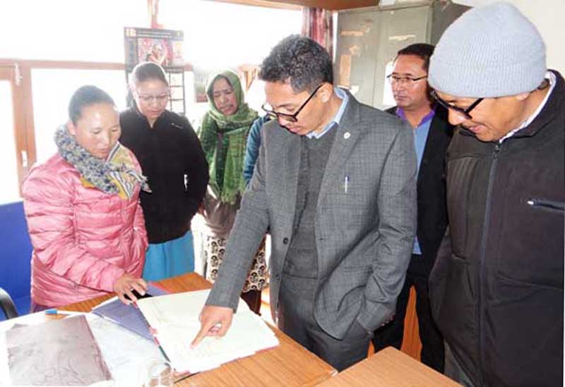 CEC Leh checking atendance register in an office during surprise inspection on Tuesday. CEC Leh checking atendance register in an office during surprise inspection on Tuesday.