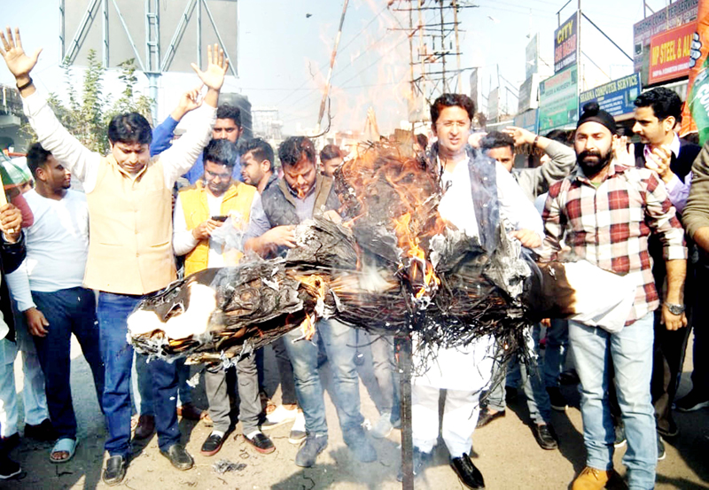 PYC activists burning effigy of BJP state president, Ravinder Raina during protest at Press Club in Jammu on Sunday. PYC activists burning effigy of BJP state president, Ravinder Raina during protest at Press Club in Jammu on Sunday.
