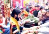 Pt Rumil Sharma performing Pooja at Bhairav Temple (left) and Bhandara being served to the devotees (right). -Excelsior/Rakesh