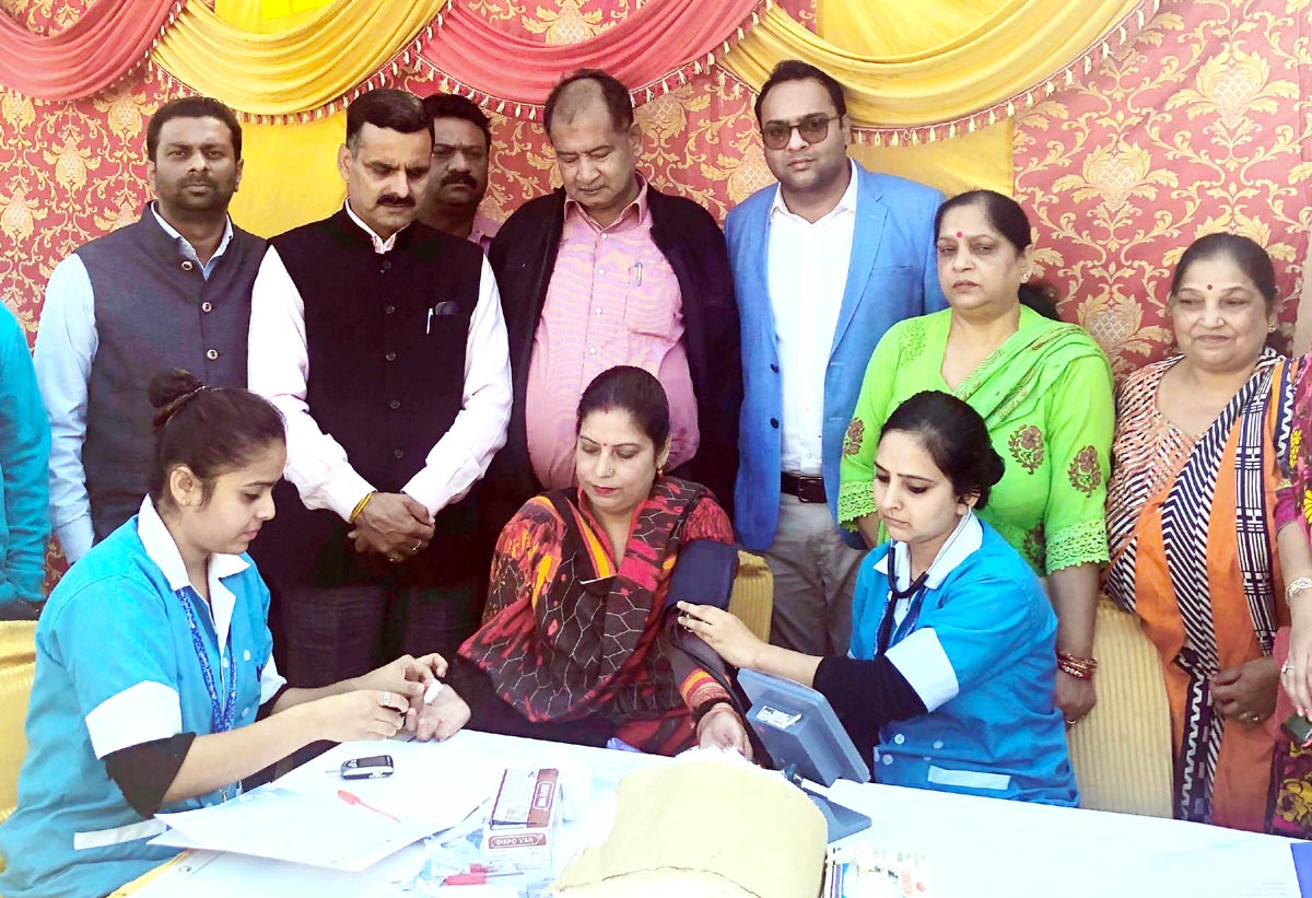 Nursing staff checking blood pressure of a patient during a super speciality camp in Jammu. Nursing staff checking blood pressure of a patient during a super speciality camp in Jammu.