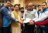 BJP Jammu district President and Corporator, Baldev Singh Billawaria handing over letters to beneficiaries under Housing for All scheme at Jammu on Thursday.