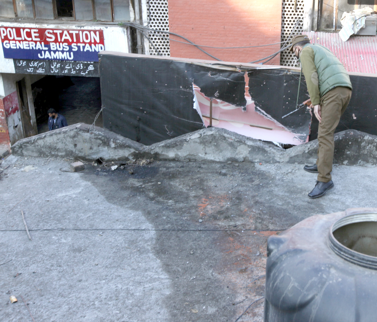 A cop inspects the site of grenade attack at Bus Stand. —Excelsior/Rakesh A cop inspects the site of grenade attack at Bus Stand. —Excelsior/Rakesh