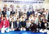 Karatekas after winning medals in State Championship posing along with dignitaries and officials in Jammu.