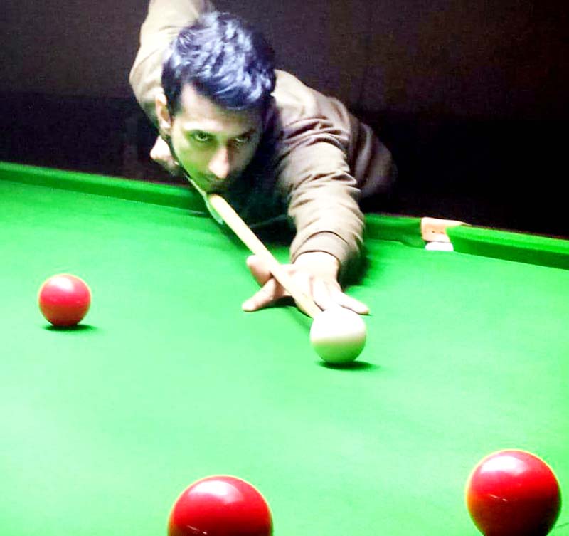 A cueist aiming at target during Six Red Ball match at Billiards Hall, MA Stadium Jammu on Thursday. -Excelsior/Rakesh A cueist aiming at target during Six Red Ball match at Billiards Hall, MA Stadium Jammu on Thursday. -Excelsior/Rakesh
