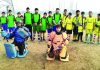 Young hockey players posing for a group photograph in Srinagar on Sunday.