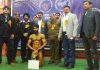 Shivam Sehdev posing along with dignitaries and officials after winning champion of champions award in District Kathua Body Building Championship.