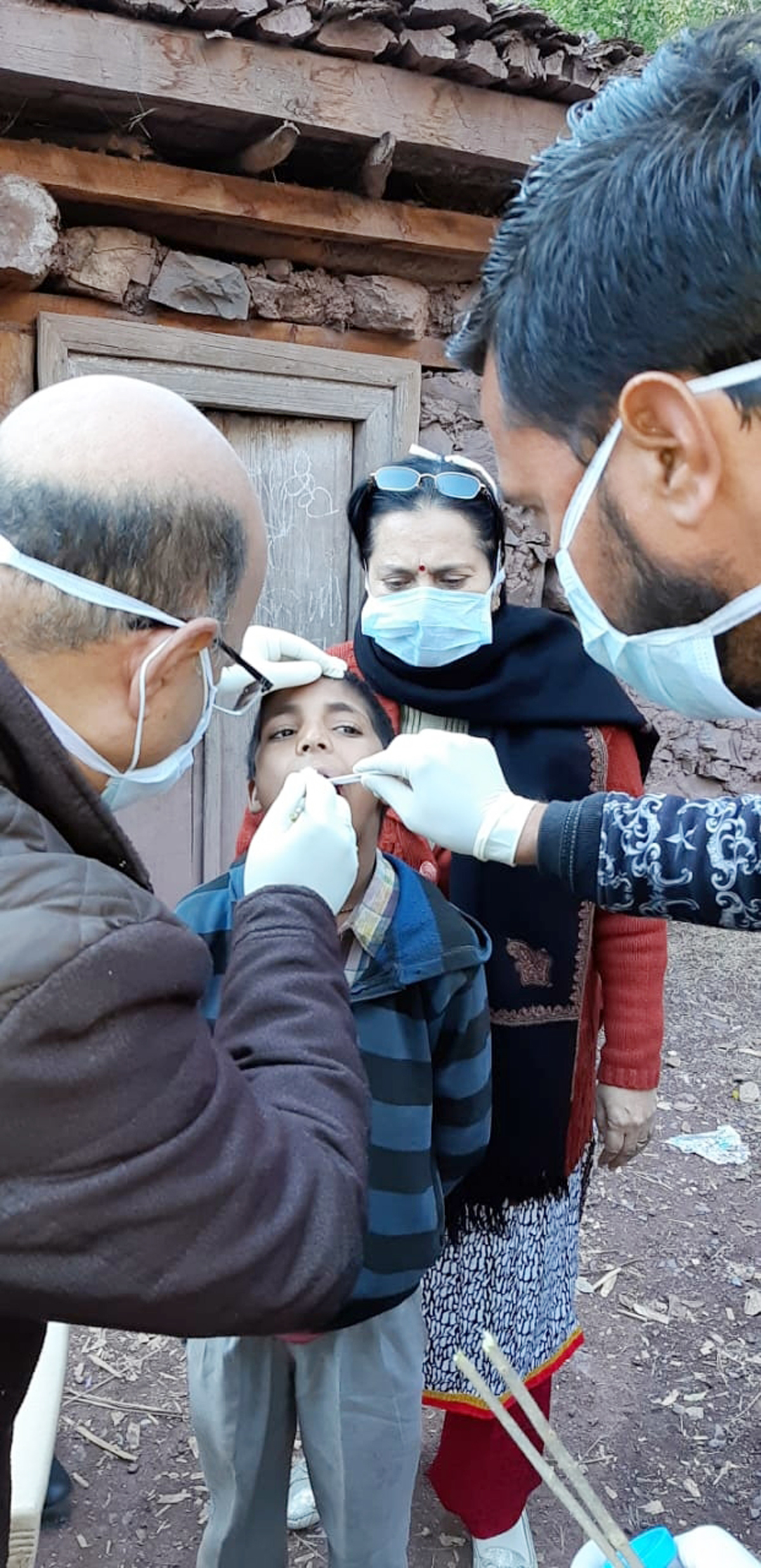 Medical team examining children in the village where two sisters died of unknown disease. Medical team examining children in the village where two sisters died of unknown disease.