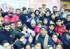 Winners of Open Kashmir Wushu Sanda Cup posing along with former Minister Nasir Aslam Wani and other dignitaries in Srinagar.