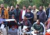 National Conference Provincial President Devender Singh Rana presenting keys of scooties to differently-abled persons on Thursday.