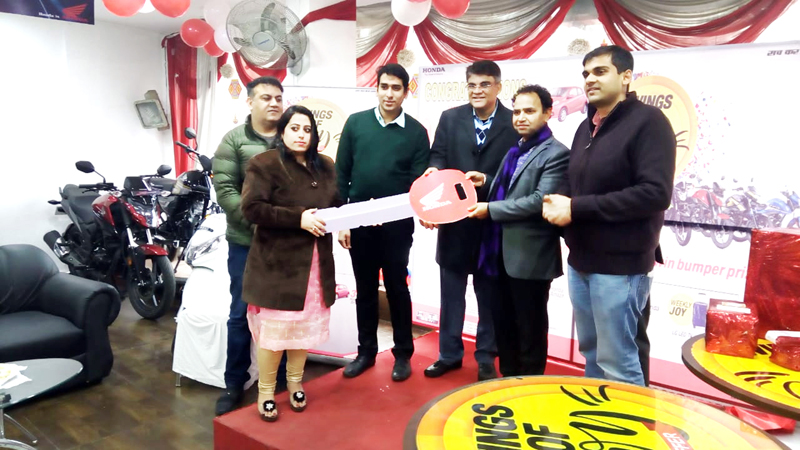 RTO Jammu Deep Raj Kaneethia handing over the keys of Brio car to Joy Club winner Anju Devi in presence of officials of Diamond Honda. RTO Jammu Deep Raj Kaneethia handing over the keys of Brio car to Joy Club winner Anju Devi in presence of officials of Diamond Honda.