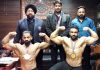 Ajeet Singh Jamwal and Deepak Sharma displaying muscles while posing for a photograph along with officials.