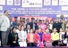 Students and dignitaries posing for group photograph during job fair.