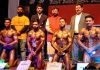 Ace bodybuilders displaying muscles while posing for a photograph along with former Minister Ch Lal Singh and other dignitaries in Jammu.