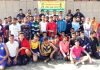 Young sportspersons posing for a group photograph during prize distribution function of Kathua District Athletics Championship.