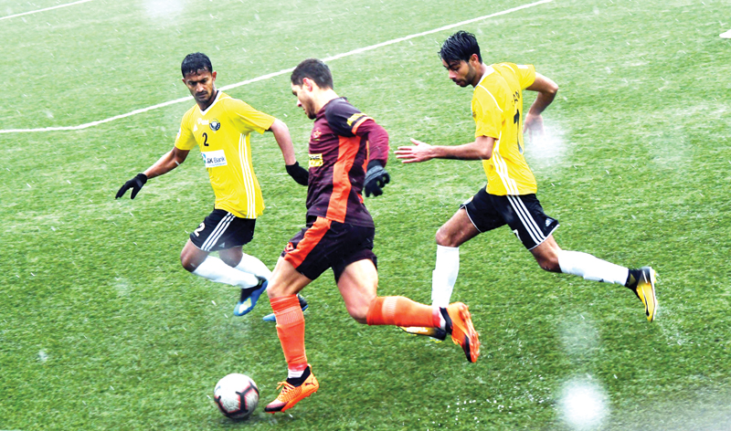 Players in action being during I-Leagues match between Real Kashmir and Gokulam Kerala played under snow and rain in Srinagar. -Excelsior/Shakeel