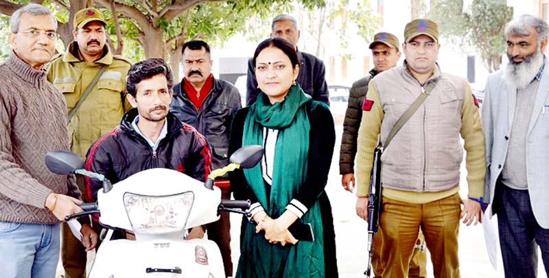 Deputy Commissioner Samba Sushma Chauhan handing over a three wheeler scooty to a specialy abled person on Friday. Deputy Commissioner Samba Sushma Chauhan handing over a three wheeler scooty to a specialy abled person on Friday.