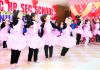 Students in colourful attires presenting dancing item while celebrating Annual Day at Shiv Public School in Jammu.