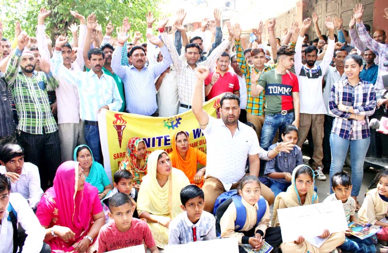 PHE daily wagers and their family members staging protest in Jammu on Monday. -Excelsior/Rakesh PHE daily wagers and their family members staging protest in Jammu on Monday. -Excelsior/Rakesh
