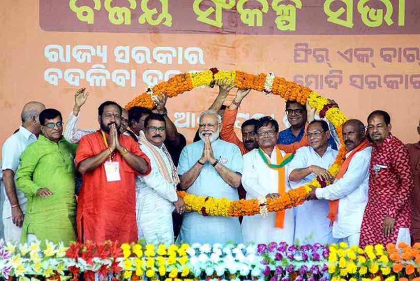 Prime Minister Narendra Modi garlanded by party workers in the presence of BJP Odisha President Basanta Kumar Panda during 'Vijay Sankalp Samavesh' public meeting ahead of Lok Sabha elections, at Bhawanipatna in Kalahandi on Tuesday. Prime Minister Narendra Modi garlanded by party workers in the presence of BJP Odisha President Basanta Kumar Panda during 'Vijay Sankalp Samavesh' public meeting ahead of Lok Sabha elections, at Bhawanipatna in Kalahandi on Tuesday.