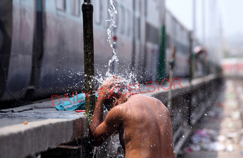 A man takes bath at Railway Station to cool himself on a hot summer afternoon in Jammu on Wednesday. —Excelsior/Rakesh A man takes bath at Railway Station to cool himself on a hot summer afternoon in Jammu on Wednesday. —Excelsior/Rakesh