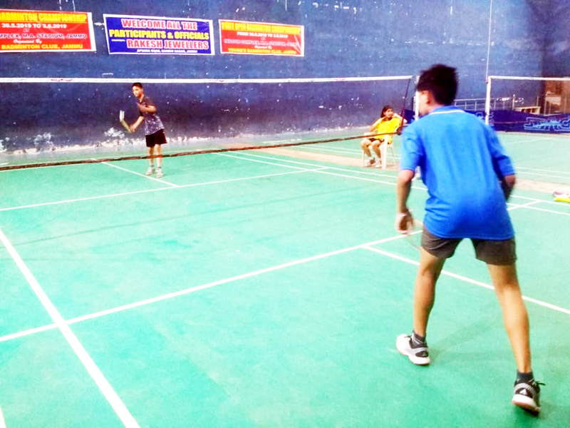 Shuttlers in action during State Open Badminton Tournament at indoor complex MA Stadium in Jammu.