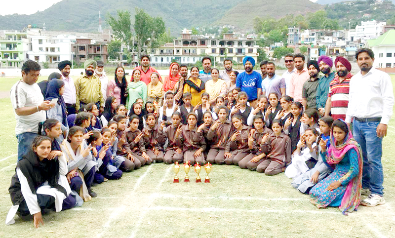 Winners of different disciplines of girls teams posing with officials at Sports Stadium Poonch on Tuesday. Winners of different disciplines of girls teams posing with officials at Sports Stadium Poonch on Tuesday.
