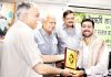 Daily Excelsior photographer, Rakesh Bakshi being presented an award of excellence during celebration of Narad Jayanti at Jammu on Sunday.