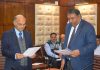 Advisor K K Sharma administering oath to Lokesh Dutt Jha as JKSERC Chairman on Thursday.