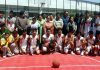 Participating teams posing with DYSSO Jammu, Chanchal Kour at Basketball court, MA Stadium in Jammu on Thursday.