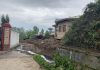 A portion of the demolished boundary wall of the PHE office in HMT Srinagar.